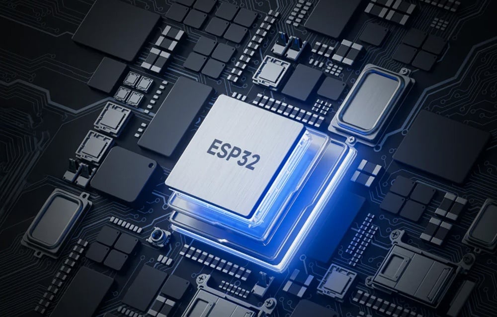 Τσιπ ESP32 τοποθετημένο σε πλακέτα με μπλε οπίσθιο φωτισμό, που περιβάλλεται από άλλα ηλεκτρονικά εξαρτήματα