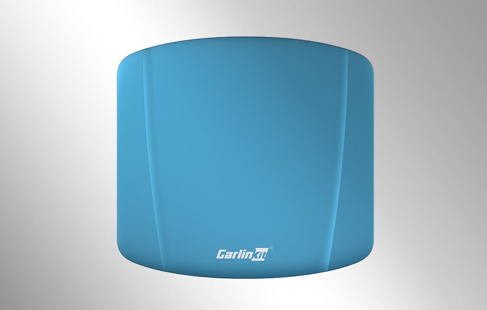 Ασύρματος προσαρμογέας Carlinkit TBOX ULTRA σε μπλε χρώμα, από πάνω, σε ανοιχτόχρωμο φόντο.