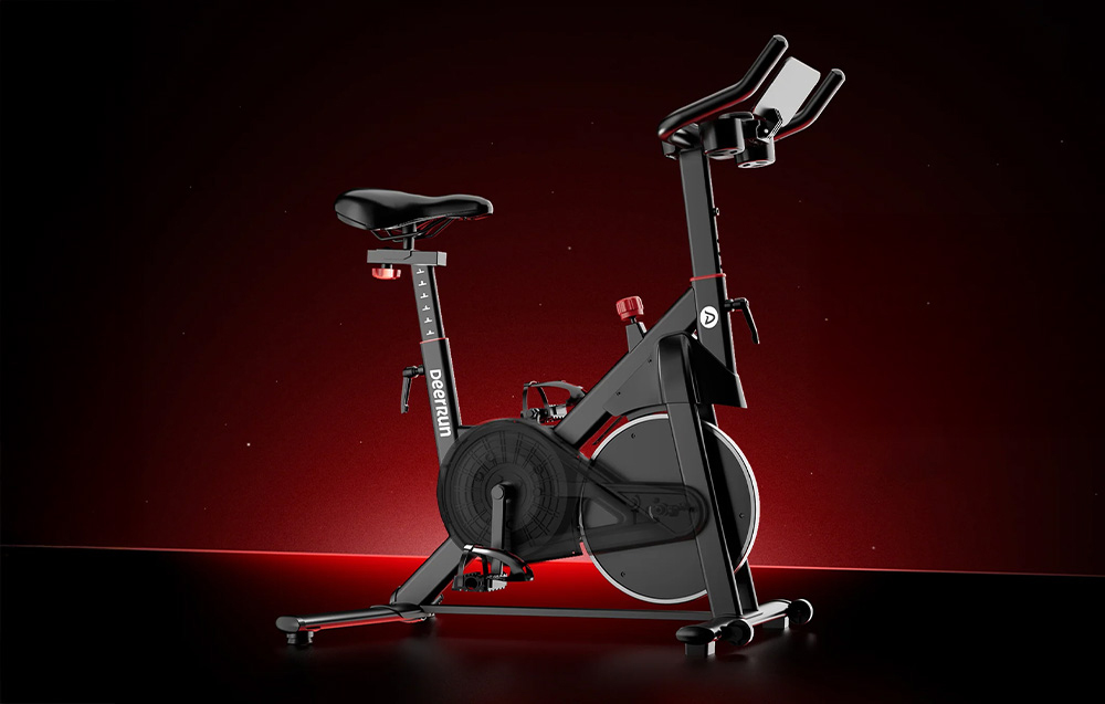 Μαύρο ποδήλατο spinning DeerRun με κόκκινες λεπτομέρειες σε σκούρο φόντο με οπίσθιο φωτισμό