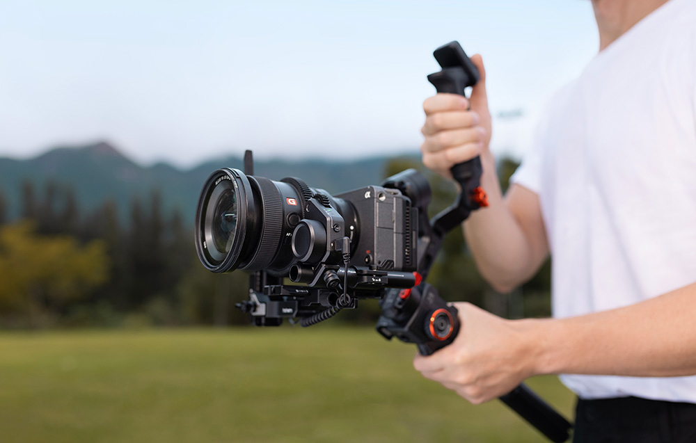 Ένα αγόρι που κρατά ένα gimbal με μια τοποθετημένη κάμερα